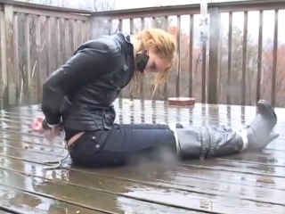 roped blond struggling in the rain